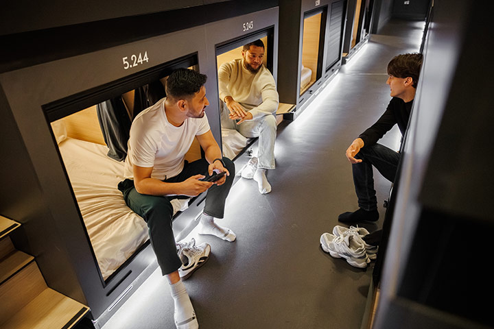 zedwell Hotels Capsules and 3 men talking