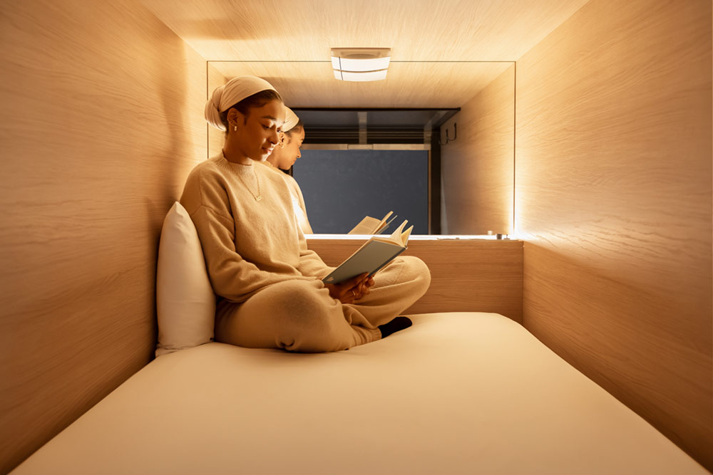 zedwell Hotels Capsule and women ready a book